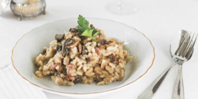 Risotto rice with mushrooms white ceramic plate