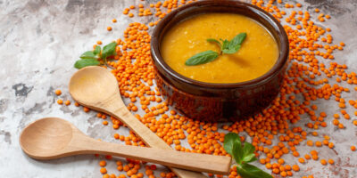 Front view delicious lentils soup with raw lentils