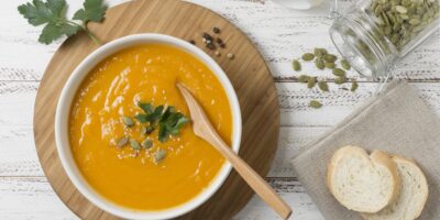 Flat lay bowl with pumpkin cream soup