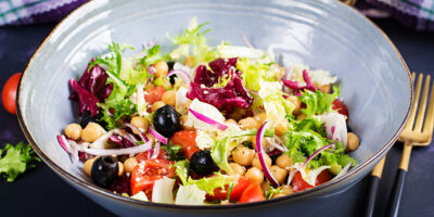 Healthy salad chickpeas tomatoes olives lettuce with red onion healthy food diet closeup food