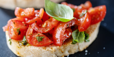 Tasty bruschetta with tomatoes basil