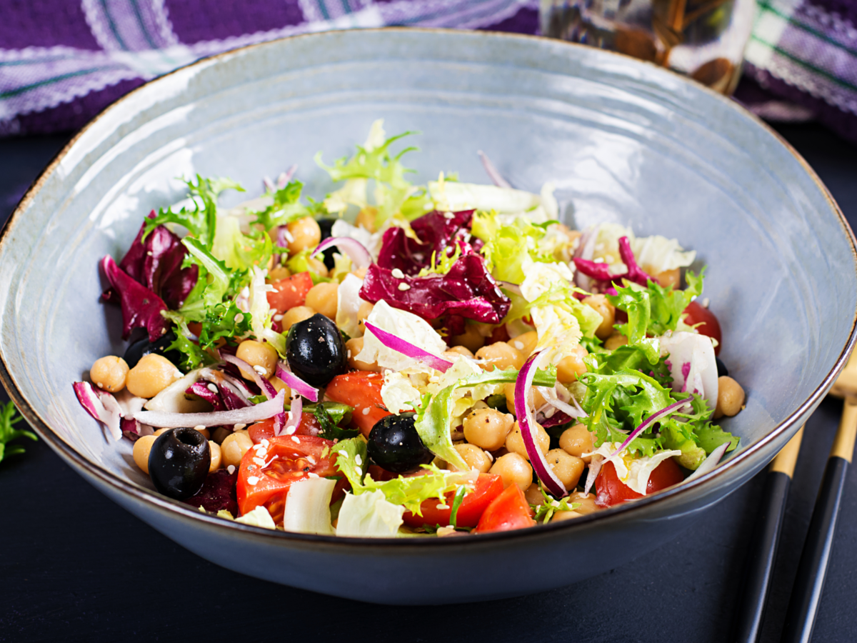 Healthy salad chickpeas tomatoes olives lettuce with red onion healthy food diet closeup food