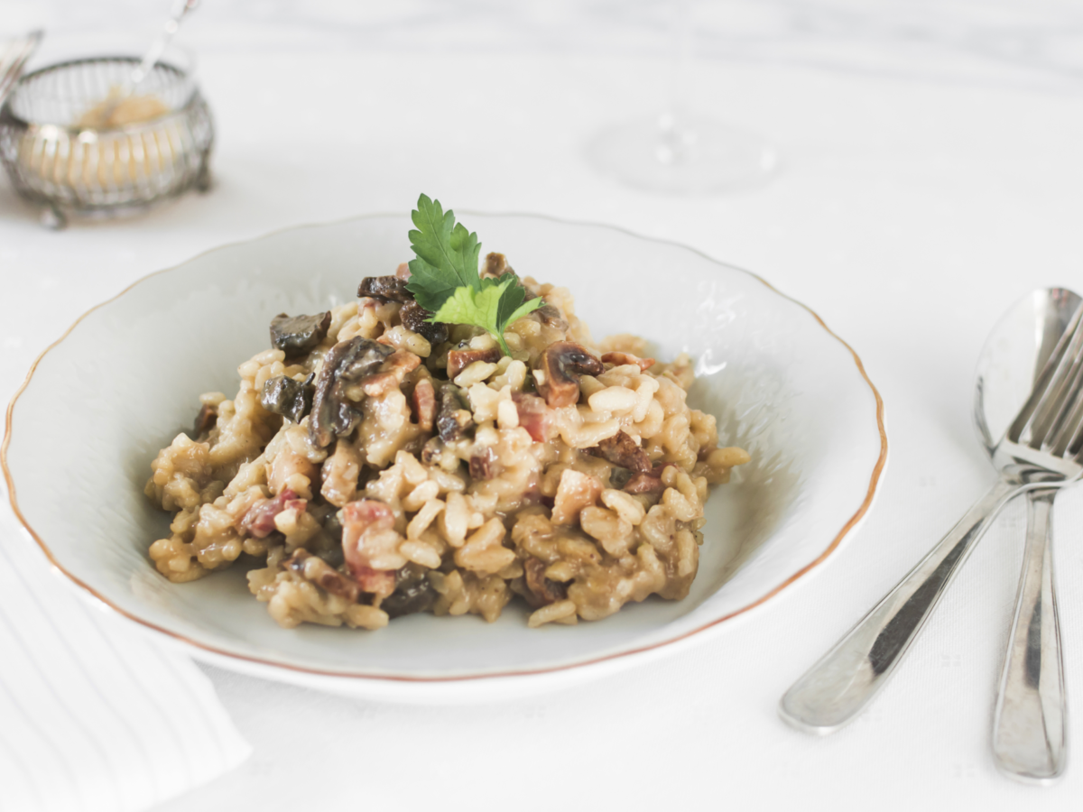 Risotto rice with mushrooms white ceramic plate