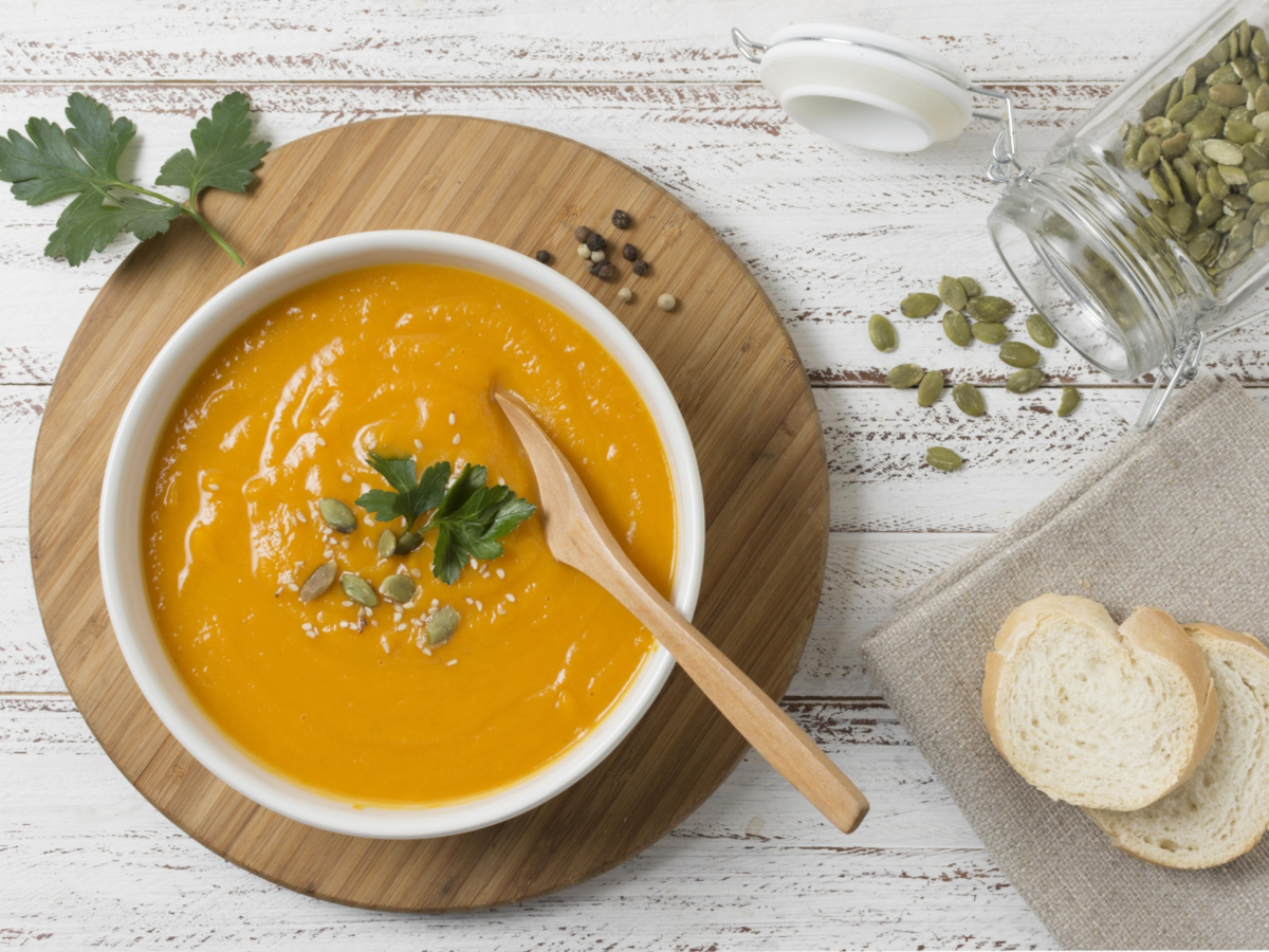 Flat lay bowl with pumpkin cream soup